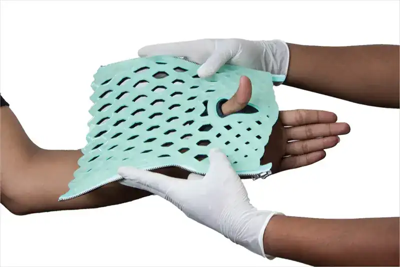 A soft FlexiOH immobilizer placed over the hand before it is zipped